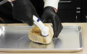 M-Vac being used on a rock to gather evidence
